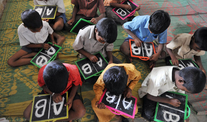 Indian schoolchildren write English alph